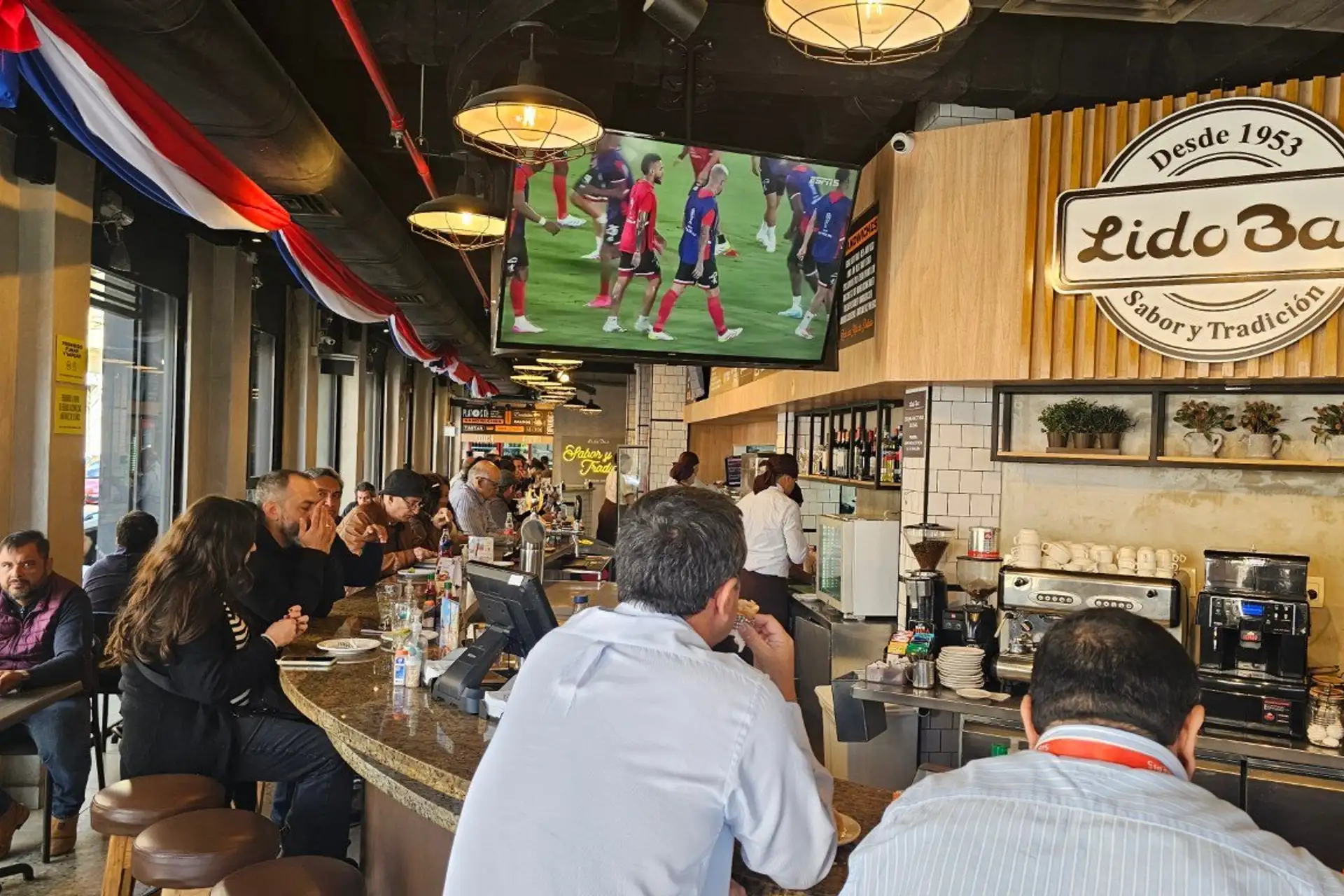 Diners at the counter of the historic Lido Bar restaurant in downtown Asuncion since 1953